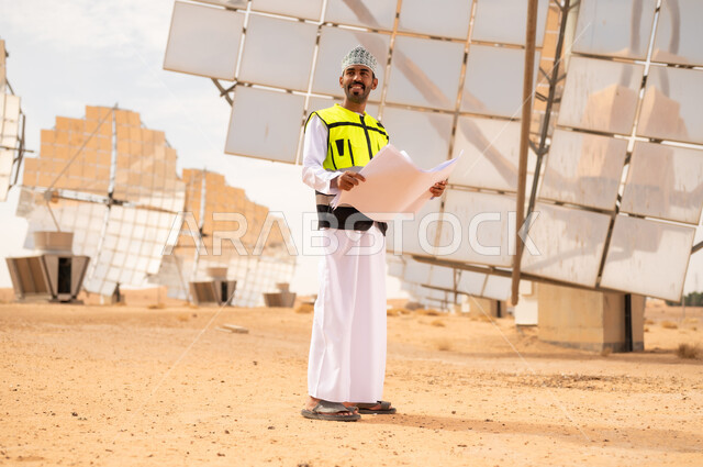 Omani Engineer with Blueprints at Solar Power Plant