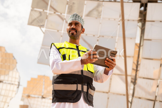 Omani Engineer with Tablet at Solar Power Plant