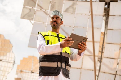 Omani Engineer with Tablet at Solar Power Plant