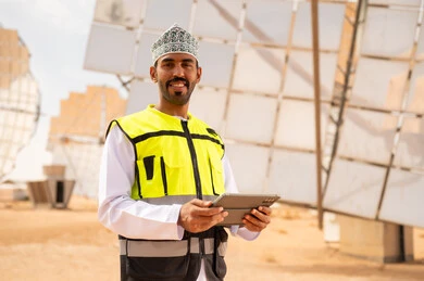 Omani Engineer in Solar Power Plant with Tablet