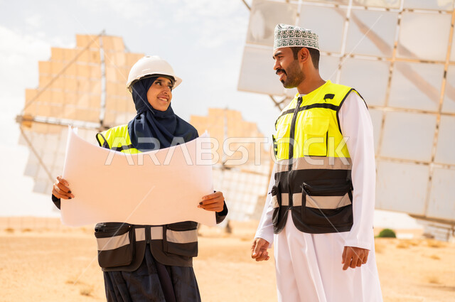 Omani Engineers with Blueprint at Solar Power Station