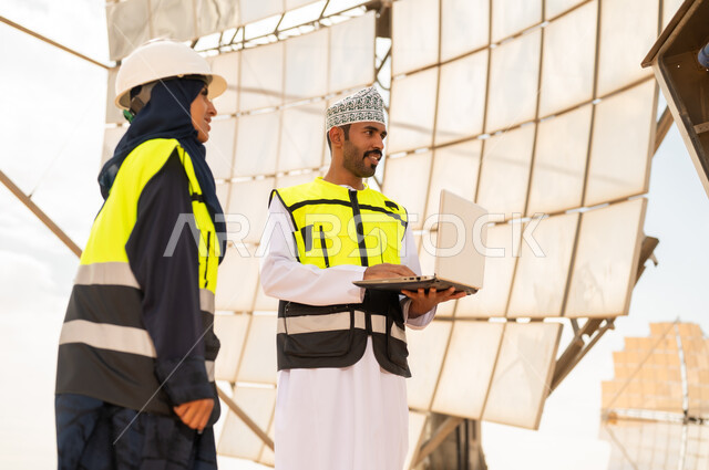 Omani Engineers at Solar Power Station with Laptop