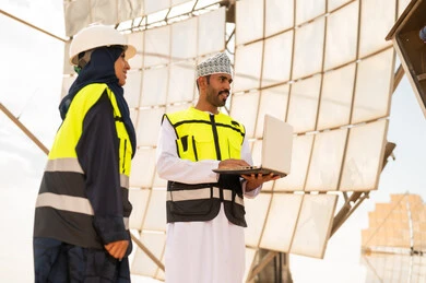 Omani Engineers at Solar Power Station with Laptop