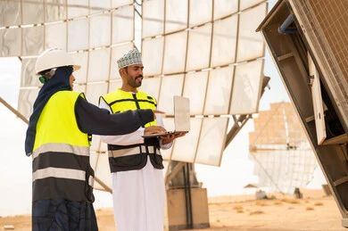 Omani Engineers at Solar Power Plant with Laptop
