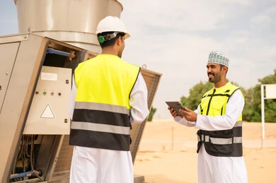 Omani Engineers Inspecting Industrial Equipment in Desert