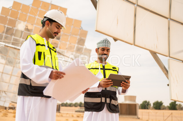 Omani Engineers at Solar Power Plant with Blueprints