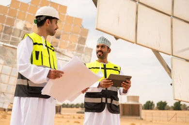 Omani Engineers at Solar Power Station with Site Plans