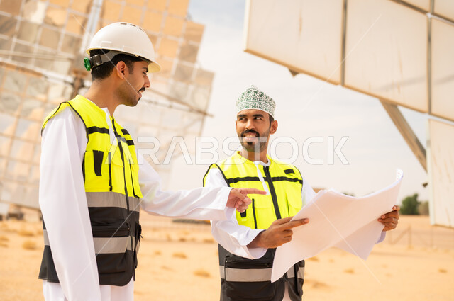 Omani Engineers at Solar Power Plant with Blueprints