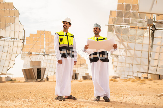 Omani Engineers in Solar Energy Field with Blueprint