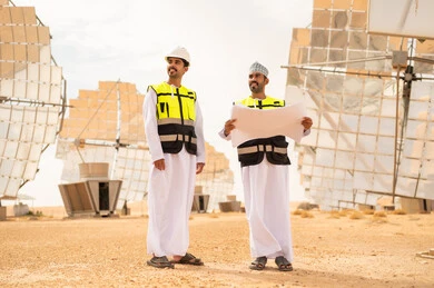Omani Engineers in Solar Energy Field with Blueprint