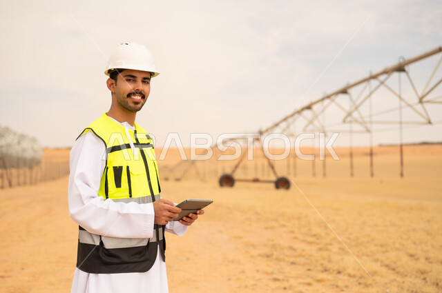 Saudi Engineer with Tablet at Desert Irrigation Farm