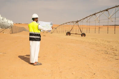 Saudi Engineer at Desert Farm with Irrigation System