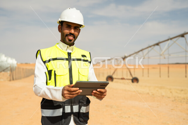 Saudi Engineer with Tablet at Desert Irrigation Farm