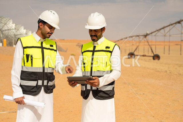 Saudi Engineers at Desert Farm with Digital Tablet
