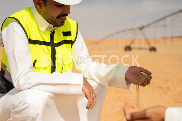Saudi Engineer Inspecting Soil at Desert Farm