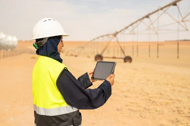 Saudi Female Engineer Using Tablet at Desert Farm