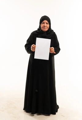 Senior Saudi Woman in Black Abaya Holding Blank Paper