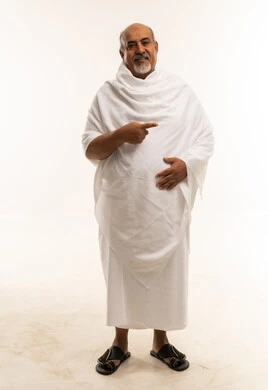 Senior Saudi Man in White Ihram Pointing to the Side