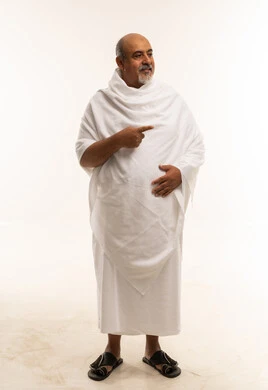 Saudi Man in White Ihram Pointing Side Studio Shot