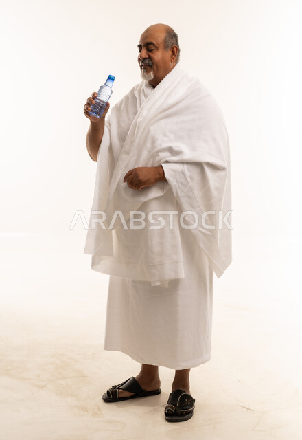 Saudi Man in Ihram Holding Water Bottle Studio