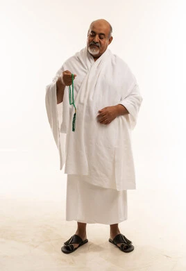 Saudi Man in Ihram Holding Prayer Beads