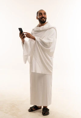 Middle Eastern Man in Ihram Holding Smartphone