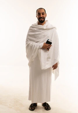 حاج سعودي بملابس الإحرام يحمل جواز السفر