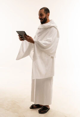 Middle Eastern Pilgrim in Ihram Holding Digital Tablet