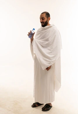 Saudi Man in Ihram Holding Water Bottle