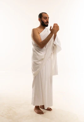Arab Man in Ihram Praying on White Background