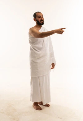 Muslim Pilgrim in White Ihram Pointing Forward