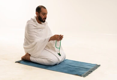 Saudi Man in Ihram with Prayer Beads on White Background