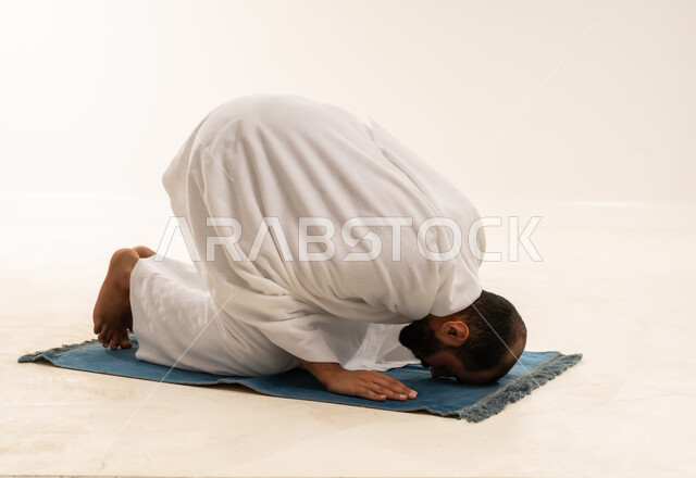 Saudi Man Performing Sujud Prayer in White Thobe