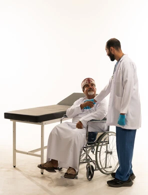 Omani Patient in Wheelchair Shaking Hands with Doctor