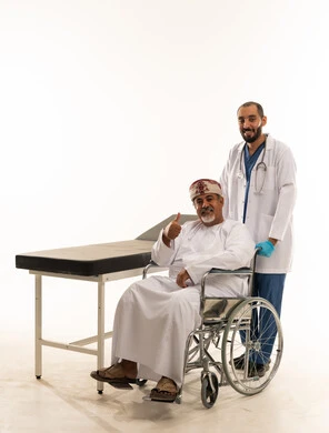 Omani Patient in Wheelchair with Doctor in Studio