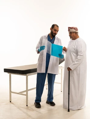 Omani Doctor Consulting Elderly Patient in Traditional Dress