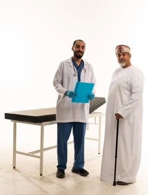 Omani Doctor and Elderly Patient in Hospital Setting