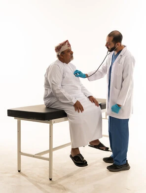 Doctor Examining Omani Senior Patient with Stethoscope