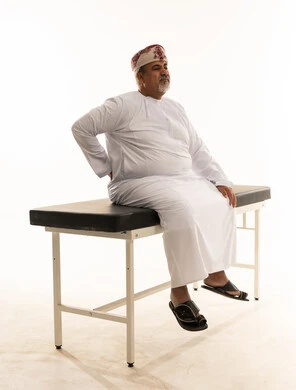 Omani Man with Back Pain on Medical Table