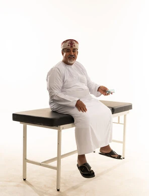 Elderly Omani Man with Medicine on Medical Table