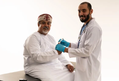 Omani Doctor Testing Blood Glucose of Elderly Patient