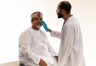 رجل عماني مسن يخضع لفحص العين لدى الطبيب