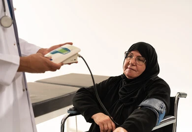 Doctor Measuring Blood Pressure of Elderly Arab Woman