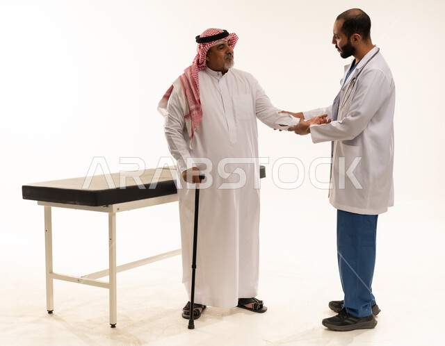 Saudi Doctor Examining Elderly Patient in Clinic