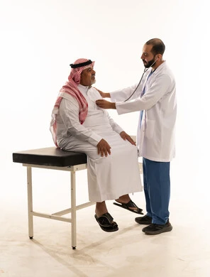 Saudi Doctor Examining Senior Patient with Stethoscope