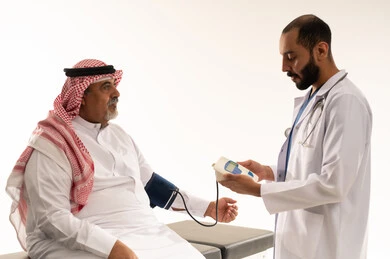 Saudi Doctor Measuring Senior Patient Blood Pressure