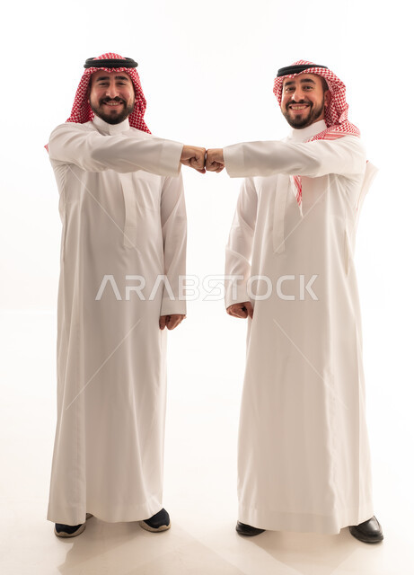 رجلان سعوديان بالزي التقليدي يتبادلان ضربة القبضة