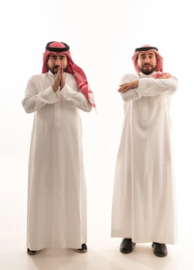 Saudi Men in Traditional Clothing with Hand Gestures