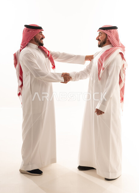 Saudi Men Shaking Hands in Traditional Dress