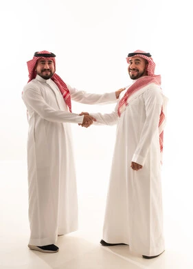Saudi Men in Traditional Dress Shaking Hands
